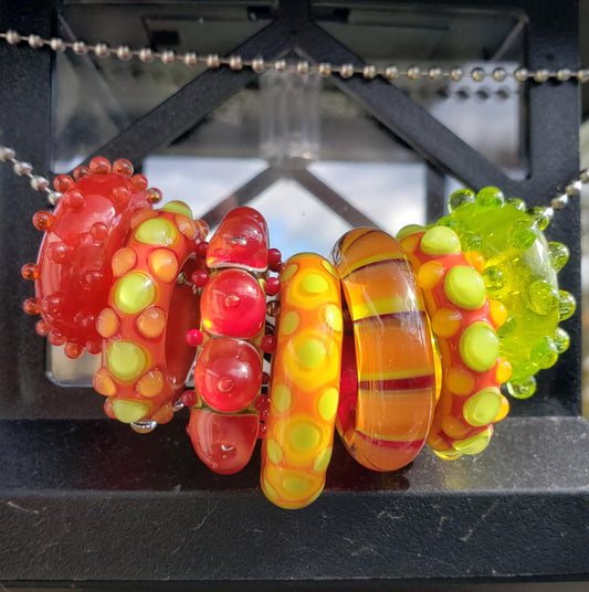 Fiery "Hot Pepper" Lampwork handmade glass slider beads colors in Transparent and Opaque tones of Red Orange Lime Green.